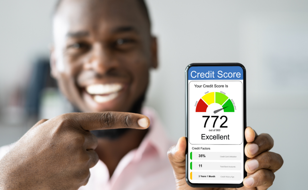 Happy man holding a cell phone showing an increased credit score